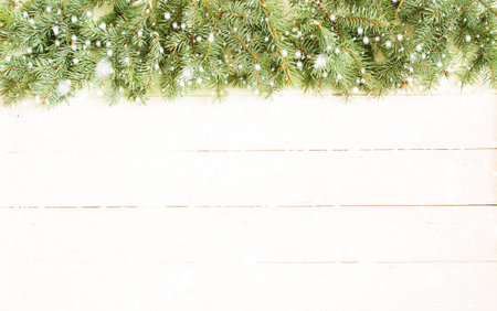 Christmas wooden background with fir tree over white wooden background. View with copy space.