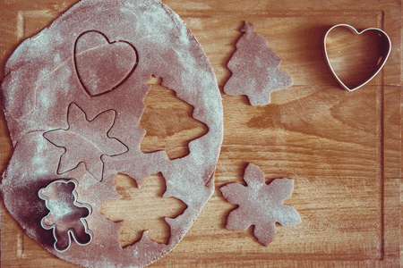 Dough for Christmas cookies made on wooden table.の写真素材