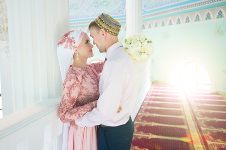 Muslim bride and groom at the mosque. Wedding ceremony.の写真素材