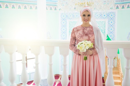 Beautiful young oriental bride preparing for wedding in the Mosque.の写真素材
