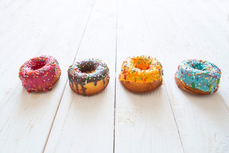 Set of donuts on white wooden background.の写真素材