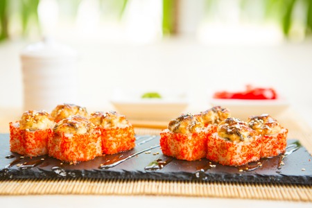 Sushi rolls on black slate surface. Japanese food. Hot fried Sushi Roll.の写真素材