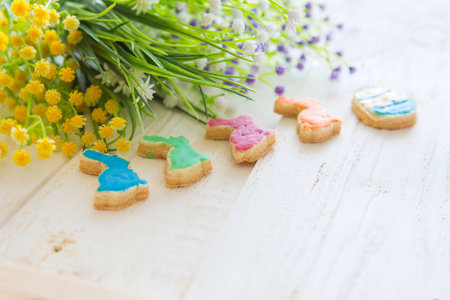 Colorful easter cookies on a white wooden background. Happy Easter concept.