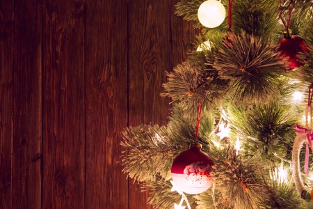 Happy Holiday! Wooden background with copy space for text near christmas tree. Living room decorated for Christmas.の写真素材