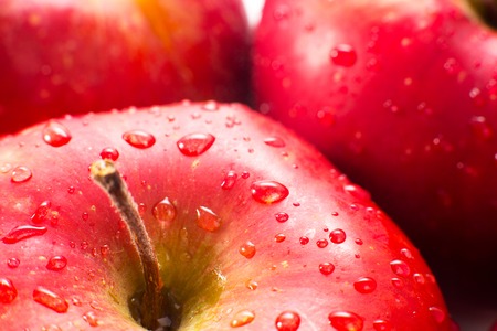 Macro of fresh red wet apples with water drops. Healthy eating.の写真素材