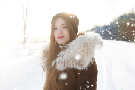 Portrait of a happy teenage girl in the snow.の写真素材