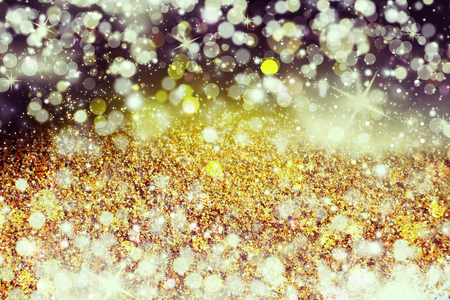 Glitter lights gold or yellow grunge background. Glitter defocused abstract Twinkly Lights and Stars Christmas Background.の写真素材