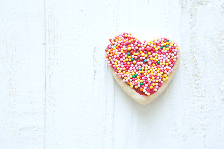 Valentine heart cookie on a white wooden backgroundの写真素材