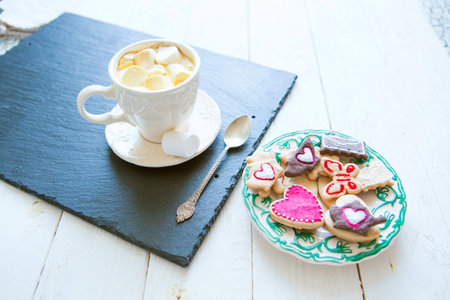 Cup of cocoa with marshmallows and cookies in the shape of hearts, Valentine's Day celebration top...