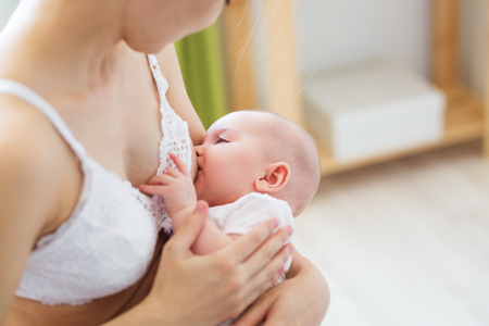 Mother breast feeding her little boy. Mom nursing and feeding baby. Close-up portrait of infant.の写真素材