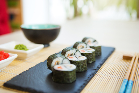 Fresh sushi rolls on black slate, top view. Sushi menu. Japanese food.の写真素材