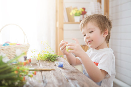 Young artist with a brush wipes himself hands
