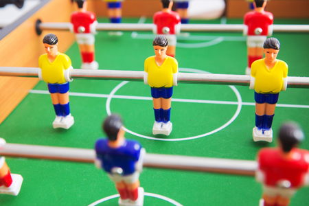 Table football game with yellow and red players and white goalkeeper. Table soccer game.の写真素材
