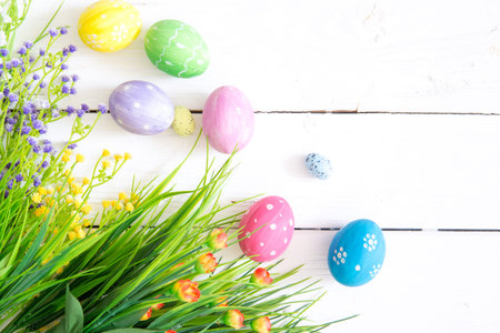 Easter eggs and branch with flowers on wooden