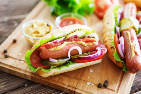 Delicious fast food. Tasty hot dogs on wooden backgroundの写真素材