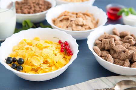 Muesli with berries and milk Healthy tasty breakfast cornflakes with strawberries, raspberries, black currants and red currants.の写真素材