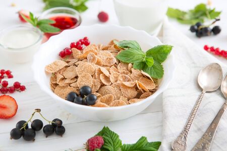 Multigrain wholewheat healthy cereal. Healthy tasty breakfast multigrain wholewheat healthy cereals with strawberries, raspberries, black currants and red currants.の写真素材