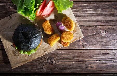 Delicious fast food. Black hamburger on plate close up with copy space.の写真素材