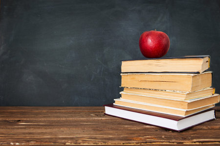 Red apple over pile of books for school concept. Education concept, toned and soft focus imageの写真素材