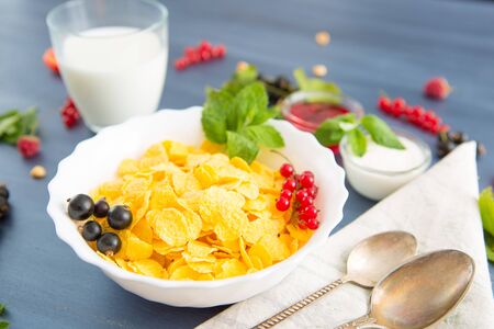bowl of granola with yogurt and berries isolated on white background, top view Healthy tasty breakfast cornflakes with strawberries, raspberries, black currants and red currants.の写真素材