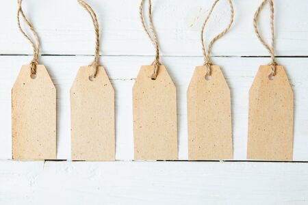 The five card badges with ropes on wooden tableの写真素材