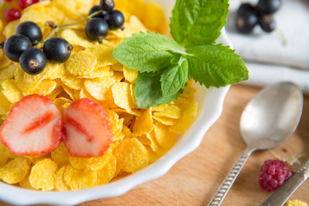 Fresh corn flakes with strawberries and milk close up Healthy tasty breakfast cornflakes with...