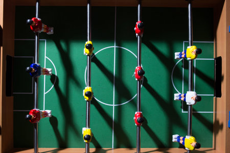 Foosball table soccer. Sport team football players