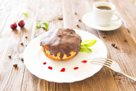 Chocolate donut or bun with an espresso on table.の写真素材