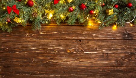 Christmas decoration and christmas lights frame on wooden background.の写真素材