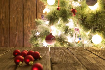 Group of colorful Christmas baubles on wooden table. Christmas decorations on wooden surface.の写真素材