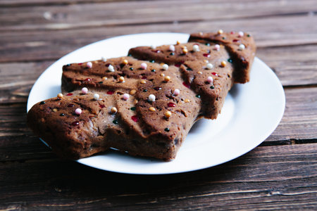 Homemade Christmas cake in the shape of a Christmas tree on a wooden table