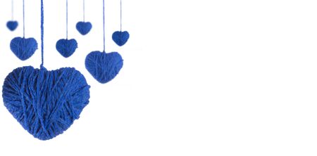 Perspective of hearts made of blue wool yarn on a white backgroundの写真素材
