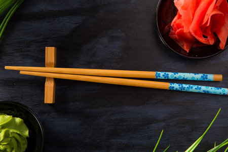 Chinese sticks with wasabi on a black background