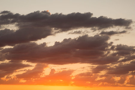 Clouds at sunset. Beautiful sky with clouds on a warm summer evening