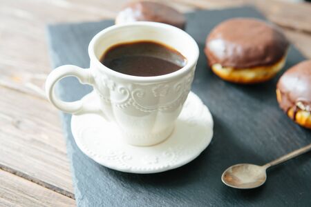 Mini donut and chocolate caramel cream and black coffee cup ,on black table toneの写真素材