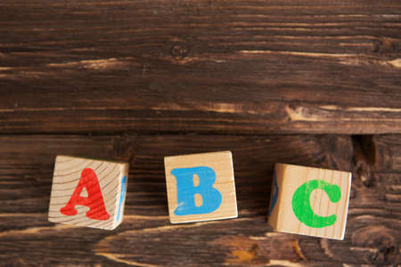 Cubes with letters ABC on rustic wooden tableの写真素材