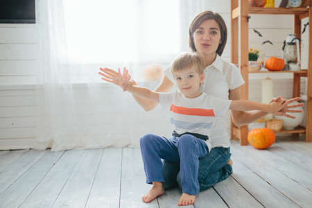 Mom and her son play in the halloween room. Happy Halloween conceptの写真素材