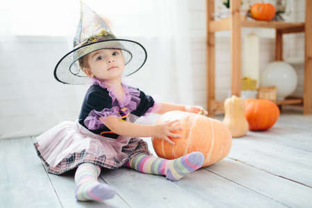 funny child girl in witch costume is ready to celebrate Halloween.の写真素材