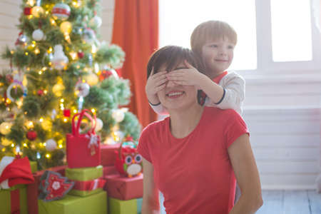Happy family and Merry Christmas. Mother and baby son at Christmas morning at treeの写真素材