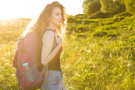 Young traveller girl enjoying a looking at sunset, active lifestyle conceptの写真素材