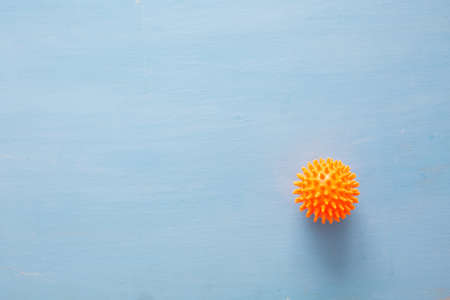 Abstract virus strain model of Coronavirus disease COVID-19 on blue wooden background with copy space.の写真素材