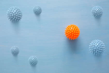 Abstract virus strain orange model of Coronavirus disease COVID-19 on blue wooden background with copy space. Virus Pandemic Protection Conceptの写真素材