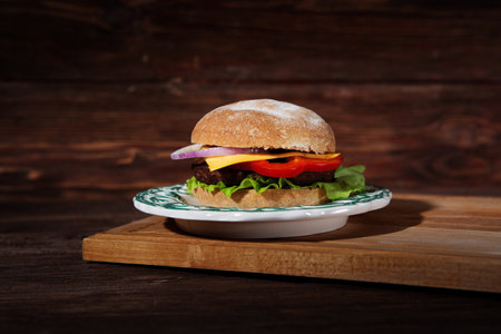 Hamburger on wood board over rustic backgroundの写真素材