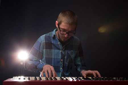 Artist playing on the keyboard synthesizer piano keys. Male musician plays a musical instrumentの写真素材