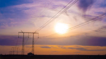 Electric high voltage pole at sunset backgroundの写真素材