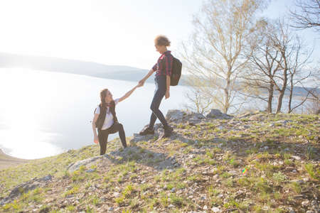 Two beautiful girls are traveling in the mountainsの写真素材