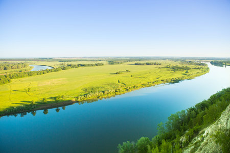 Spring in Valley with river: Infectious greens, winding streams, and volatile skies of spring.の写真素材