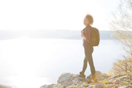 Woman rising hands on mountain in morning with vintage lightの写真素材