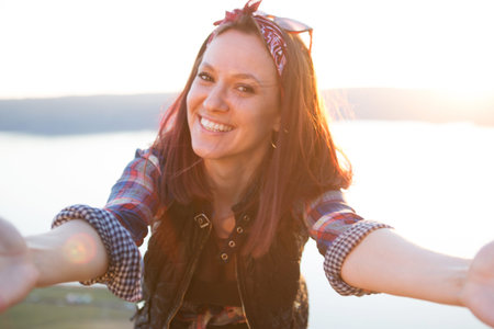 Smiling young woman takes a selfie in Mountainsの写真素材