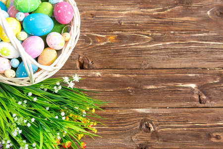 Easter eggs in the basket of wooden boardsの写真素材